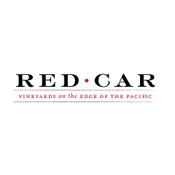 Red Car Vineyards logo featuring a red dot between the words and the tagline 'Vineyards on the Edge of the Pacific'.